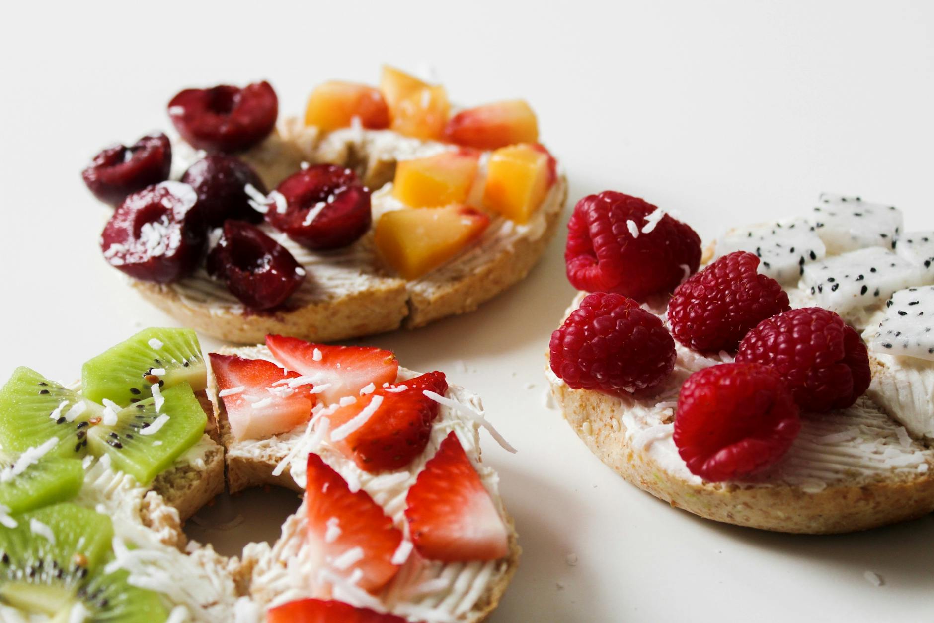 sliced variety of fruits on round baked bread